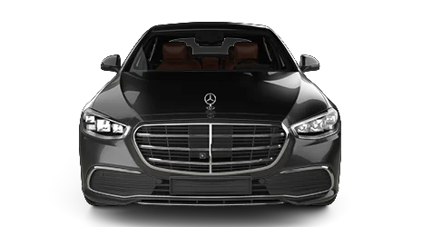 A black Mercedes-Benz luxury sedan is shown from the front, featuring a large grille with the Mercedes emblem, sharp headlights, and a view of its brown leather interior
