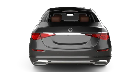 A black Mercedes-Benz luxury sedan is viewed from the rear, highlighting its sleek taillights, chrome trim, and spacious interior with brown leather seats on a plain white background.