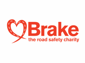 The Brake logo features a heart-shaped road graphic in red, followed by the word "Brake" in bold red letters, with the tagline "the road safety charity" below, also in red.