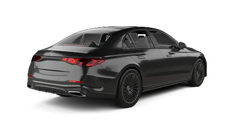 A black Mercedes-Benz sedan is shown from a rear-side angle, featuring its modern taillights, dual chrome exhausts, and sleek body lines